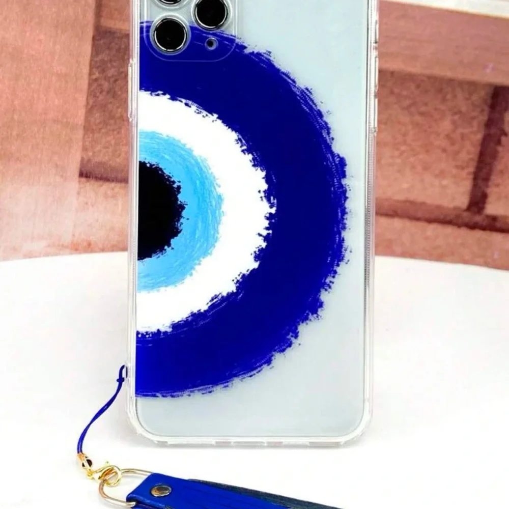 Transparent cell phone case with evil eye pattern with fringe